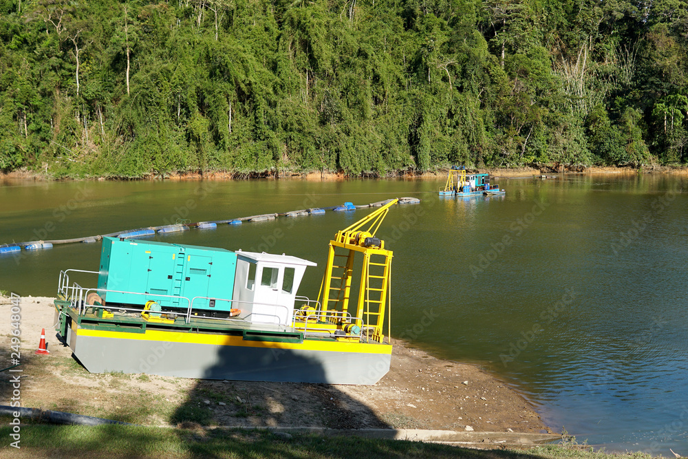 Naklejka premium Sand dredging boat ,pump and excavator removing sand from the river bed - Image