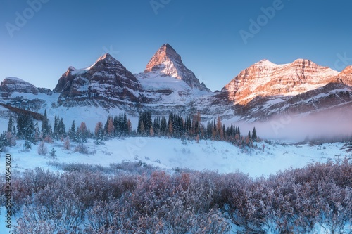 Winter sunrise. Mount Assiniboine, also known as Assiniboine Mountain, is a pyramidal peak mountain located on the Great Divide, on the British Columbia/Alberta border in Canada. 