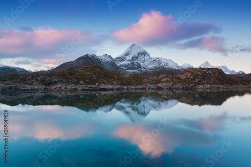 Sunset or sunrise panoramic view on stunning mountains in Lofoten islands with first snow  Norway  Mountain coast landscape  Arctic circle. Concept. Amazing Nature background