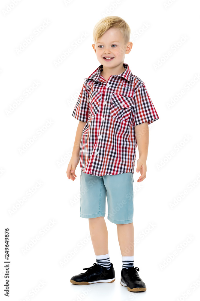 A cute little boy in a shirt and shorts. A cute little boy in a shirt and shorts.