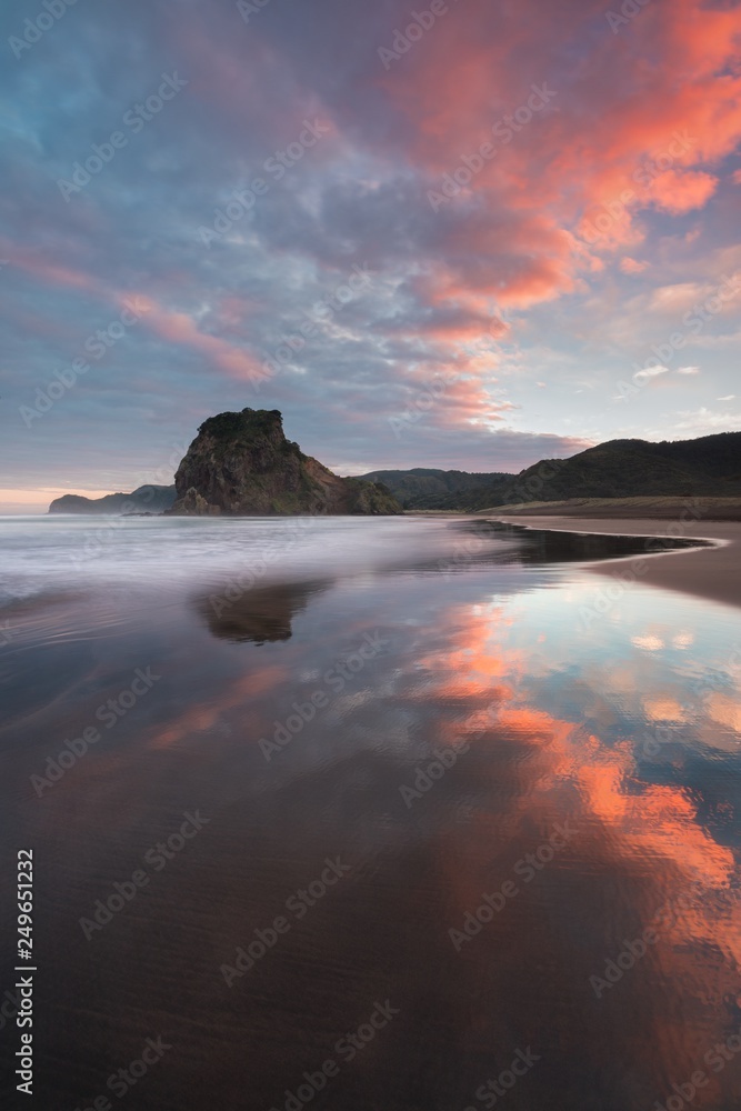 Piha beach is a coastal settlement on the western coast of the Auckland Region in New Zealand. It is one of the most popular beaches in the area. Beautiful summer sunrise background