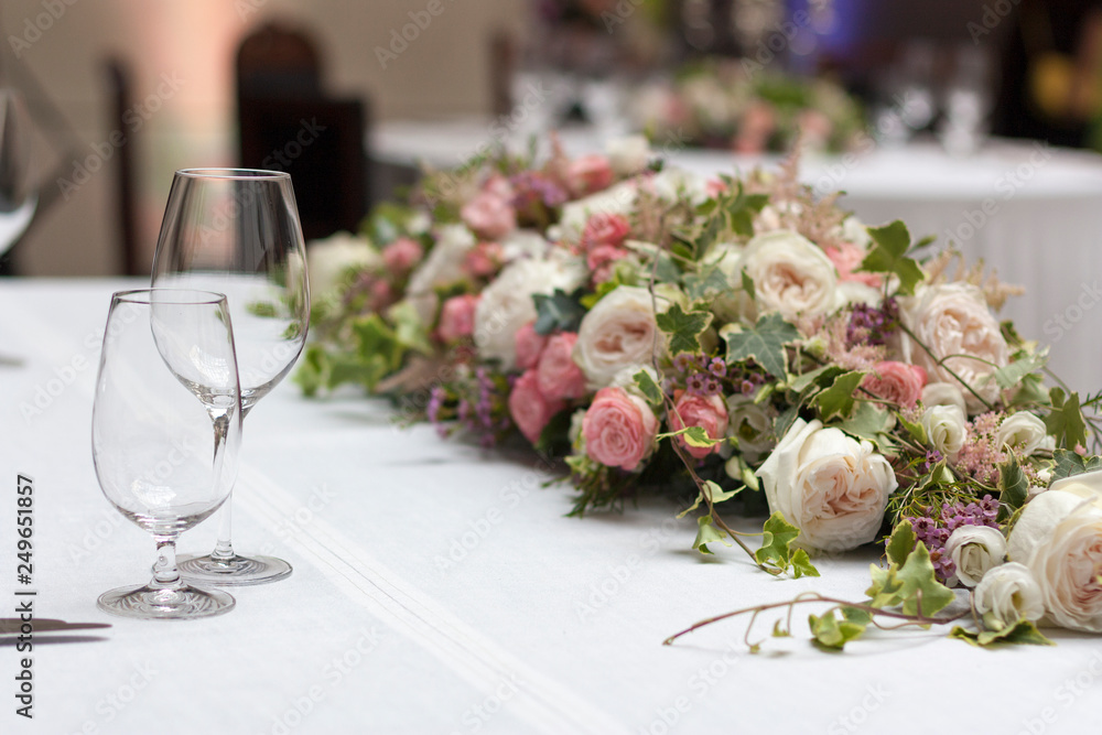 Beautiful floral arrangement on the table in the restaurant on the wedding day