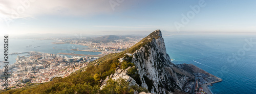 Panorama of top of Gibraltar Rock (United Kingdom), in Upper Rock Natural Reserve: on the left town and bay, La Linea town in Spain at the far end, Mediterranean Sea on the right.