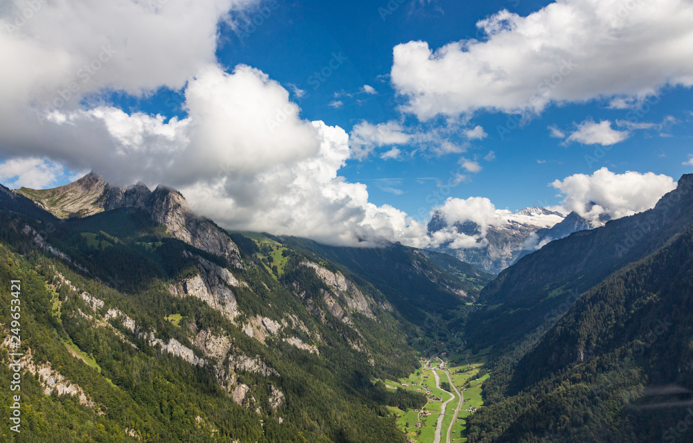 Helicopter walk over the Swiss Alps in the town of Interlaken. View of the valley, alpine mountains and cloudy sky. Switzerland Helicopter walk over the Swiss Alps in the town of Interlaken. View of the valley, alpine mountains and cloudy sky. Switzerland