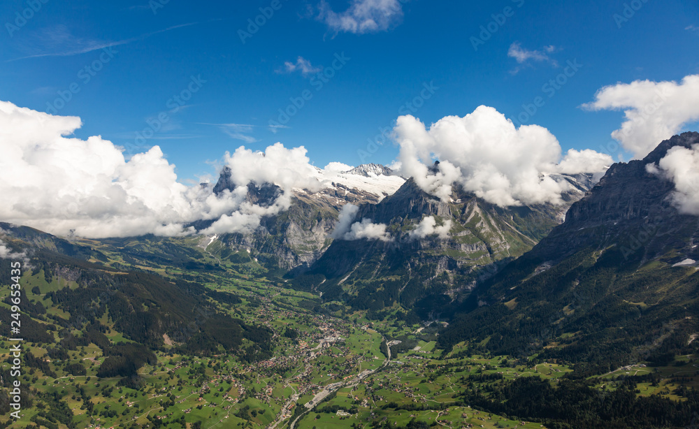 Helicopter walk over the Swiss Alps in the town of Interlaken. View of the valley, alpine mountains and cloudy sky. Switzerland Helicopter walk over the Swiss Alps in the town of Interlaken. View of the valley, alpine mountains and cloudy sky. Switzerland