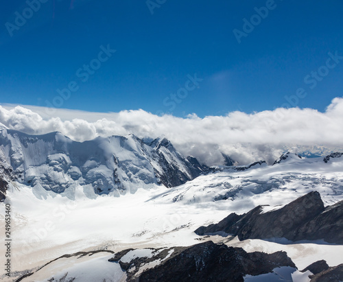 Helicopter walk over the Swiss Alps in the town of Interlaken. View of the mountains, clouds, snow and glacier. Switzerland