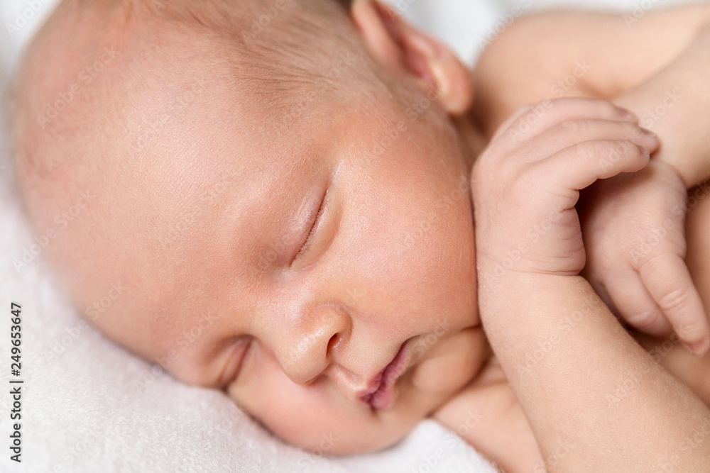 Newborn baby boy on a white background. Baby is sleeping. Boy sleeping with arms under his head Newborn baby boy on a white background. Baby is sleeping. Boy sleeping with arms under his head