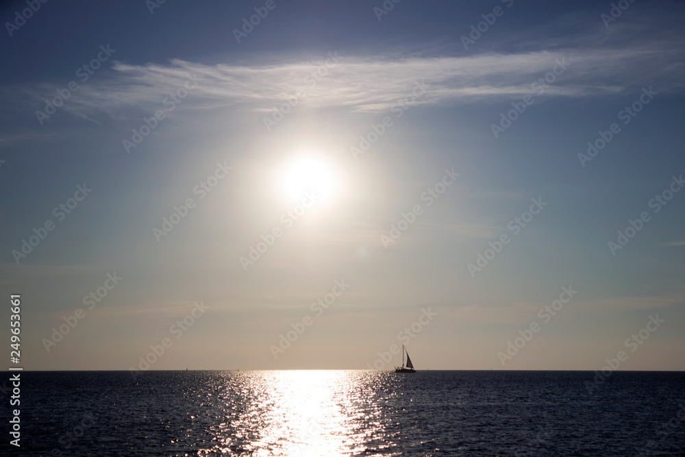 Silhouette of a yacht in the Black sea at dawn, quiet and calm, background