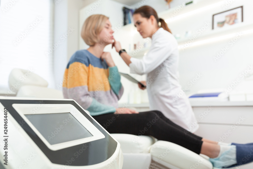 Professional woman cosmetologist in beauty clinic consulting young female client. Skin Care concept Professional woman cosmetologist in beauty clinic consulting young female client. Skin Care concept
