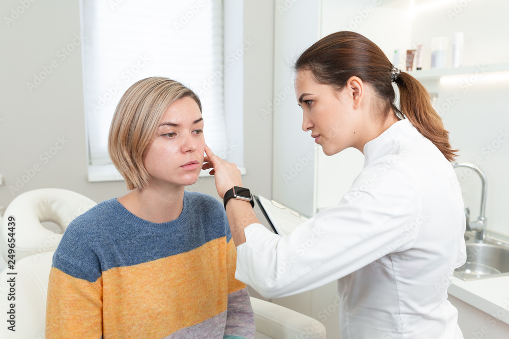 Professional woman cosmetologist in beauty clinic consulting young female client. Skin Care concept Professional woman cosmetologist in beauty clinic consulting young female client. Skin Care concept