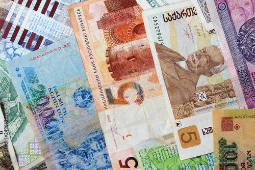 Different countries money background close up. Belarusian rubles, Georgian lari, Polish zloty, Israeli shekels, Vietnamese dongs