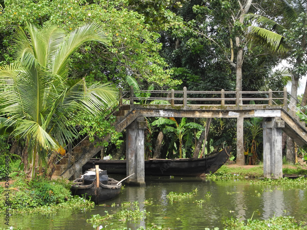 Boats near the shore and the bridge to the backwaters in Kerala Kochi Boats near the shore and the bridge to the backwaters in Kerala Kochi