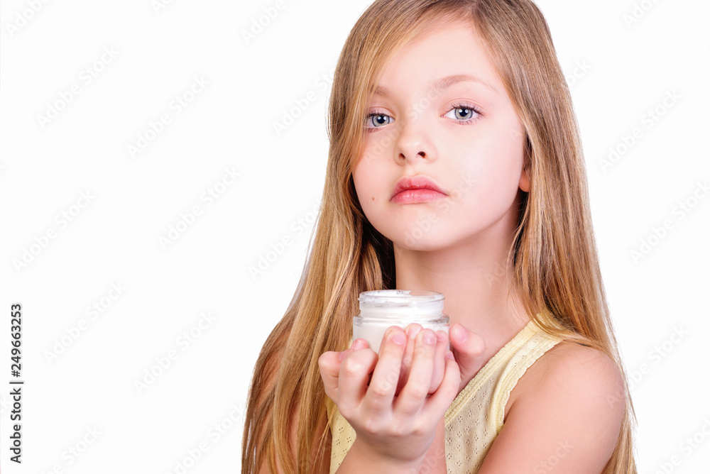 Portrait of little kid applying on facial cream isolated on white Portrait of little kid applying on facial cream isolated on white