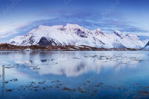 Panoramic landscape, winter mountains and fjord reflection in water. Norway, the Lofoten Islands. Colorful winter sunset or sunrise above the arctic circle. Christmas time concept © Michal