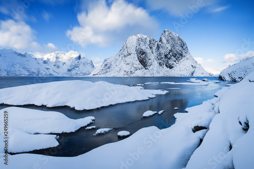 Panoramic landscape, winter mountains and fjord reflection in water. Norway, the Lofoten Islands. Colorful winter sunset or sunrise above the arctic circle. Christmas time concept