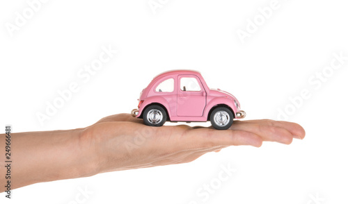 Hand holding toy car isolated on white. Insurance concept