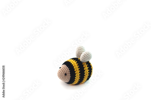 Little knitted bee for baby on white background, knitted toy