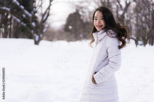 Beautiful young asian woman smiling happy for travel in snow winter season