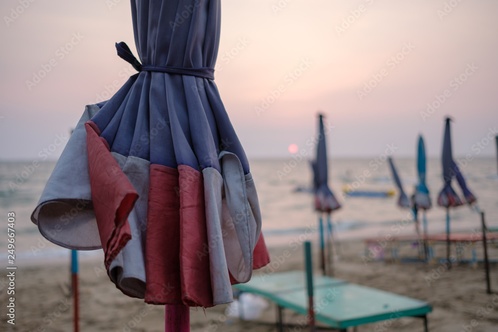Large umbrella near the sea during beutiful sunset