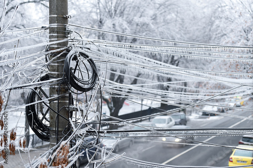 Electricity cables covered in ice after frozen rain phenomenon photo