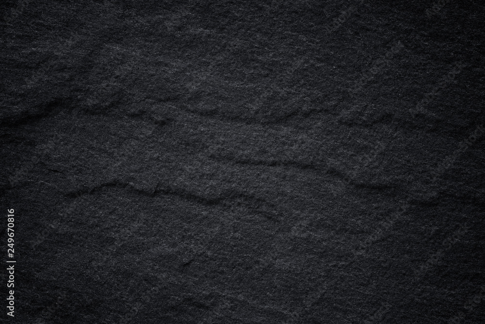 Dark grey black slate background or natural stone texture.