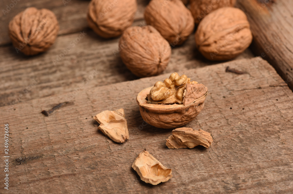 Walnut kernels and whole walnuts on rustic old oak table. Walnut kernels and whole walnuts on rustic old oak table.