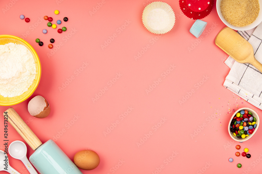 Baking or cooking ingredients on pink background, flat lay Baking or cooking ingredients on pink background, flat lay