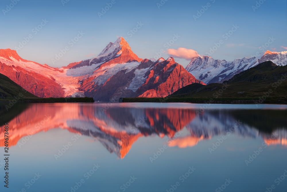 Beautiful evening panorama from Bachalp lake / Bachalpsee, Switzerland. Picturesque summer sunset in swiss Alps , Grindelwald, Bernese Oberland, Interlaken, Europe. Beauty of nature concept background