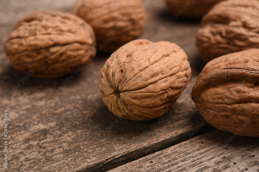 Walnut kernels and whole walnuts on rustic old oak table. Walnut kernels and whole walnuts on rustic old oak table.
