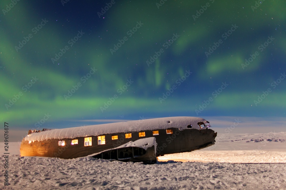 Aurora borealis above the plane. Vík, Iceland. Green northern lights. Starry sky with polar lights. Night winter landscape with aurora Aurora borealis above the plane. Vík, Iceland. Green northern lights. Starry sky with polar lights. Night winter landscape with aurora