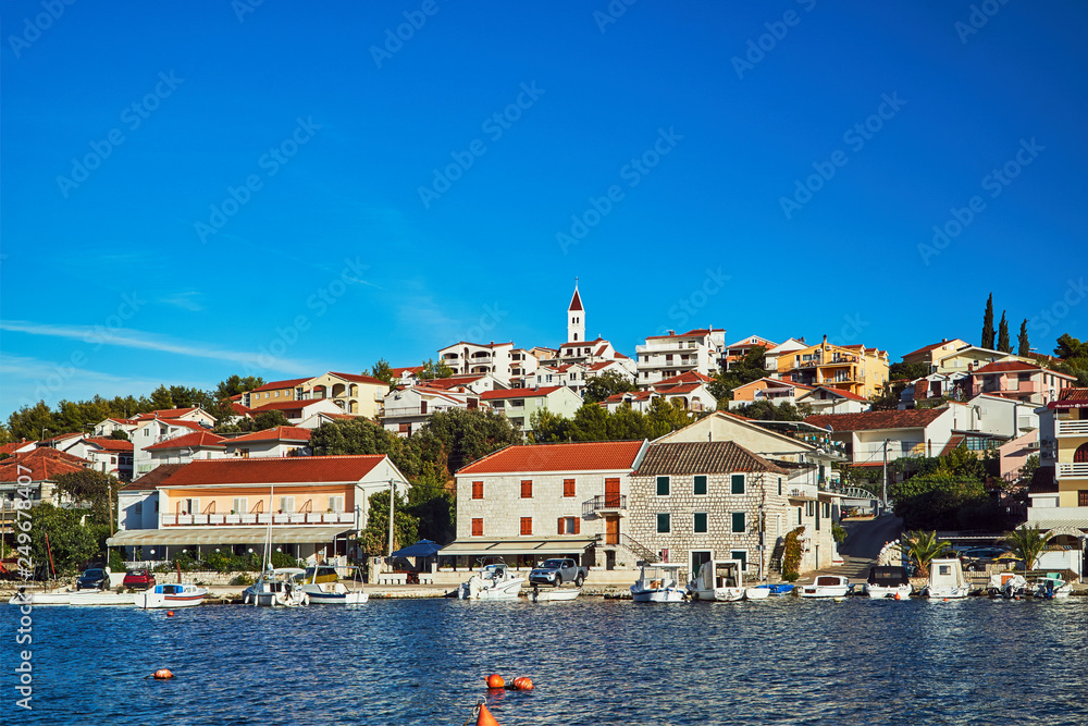 Boats and sailboats in the marina in the city of Seget Vranjica in Croatia.