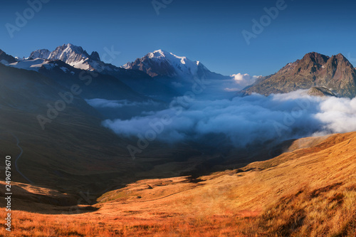 A panoramic view on Chamonix valley from in summer sunny day. The area is the stage of the popular Mont Blanc Tour, France. Beautiful holidays day in Alpes. Amazing background landscape concept.