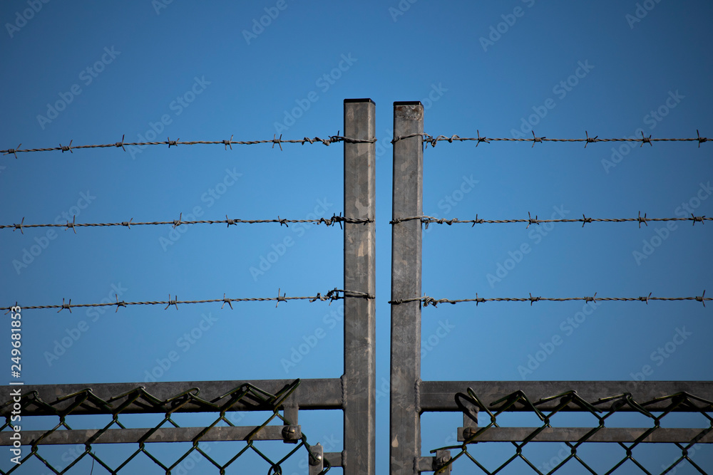 Barbed wired fence providing security to farmland in rural Hampshire Barbed wired fence providing security to farmland in rural Hampshire