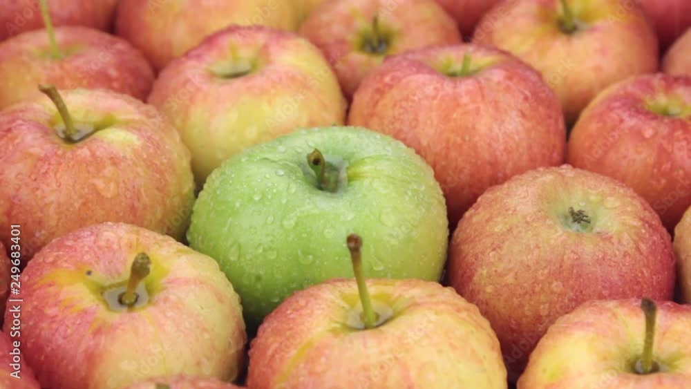 Raindrops falling on rotating apples. Close-up. Raindrops falling on rotating apples. Close-up.