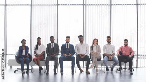 Young professionals on job interview. University graduates trying to find work. Waiting in the lobby of an office building