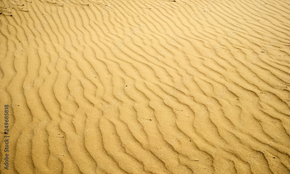 Beautiful patterns of sand dunes, formed by the wind on the sandy coast Beautiful patterns of sand dunes, formed by the wind on the sandy coast