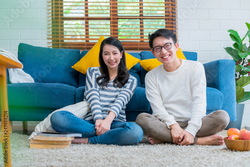 sweet lovey asian family couple sit talk good conversation on sofa in living room house background photo