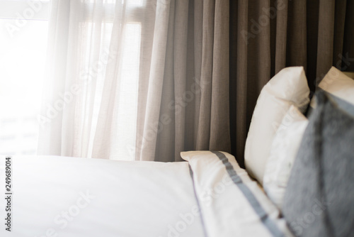Fototapeta Naklejka Na Ścianę i Meble -  Bed maid-up with clean white pillows and bed sheets in beauty bedroom. Close-up. interior background