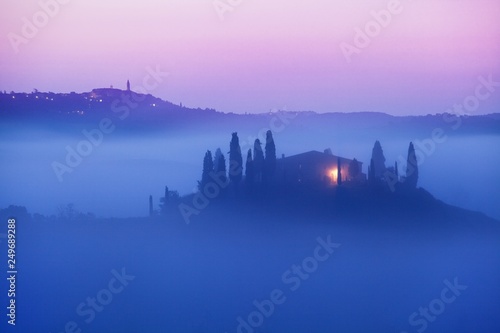 Tuscany landscape at sunrise. Typical for the region tuscan farmhouse, hills, vineyard. Italy Fresh Green tuscany landscape in spring time. Beautiful foggy landscape concept © Michal