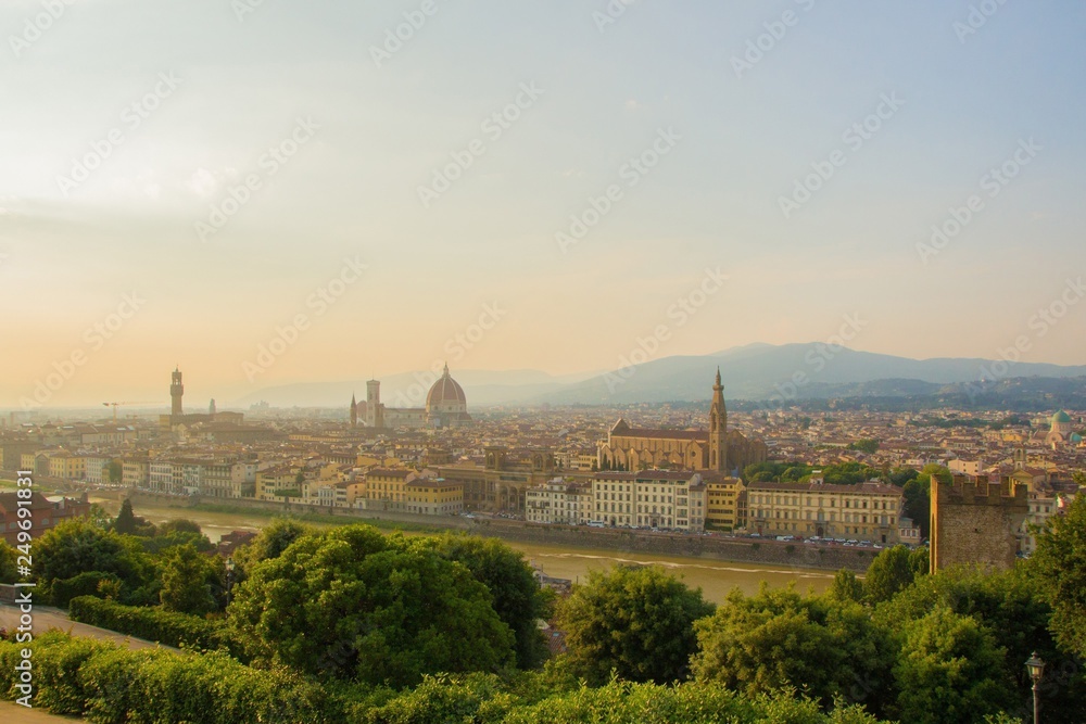 View of the Cathedral of Santa Maria del Fiore (Duomo), Basilica of Santa Croce, and Arnolfo tower of Palazzo Vecchio. Amazing evening golden hour light. Florence, Italy.
