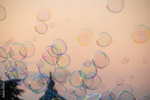 Soap bubbles soar in the air. Beautiful evening sunset in Florence. Soap bubbles evening sky. Florence, Italy.