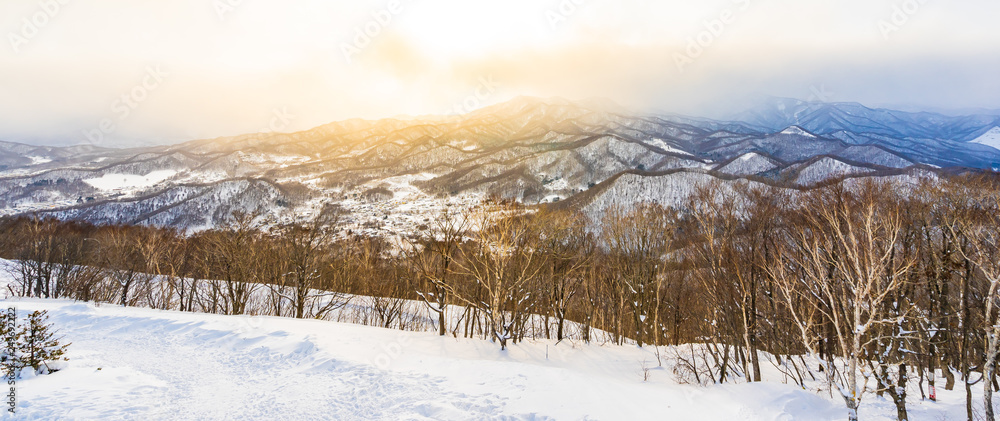 Beautiful landscape with mountain around tree in snow winter season at sunset time Beautiful landscape with mountain around tree in snow winter season at sunset time