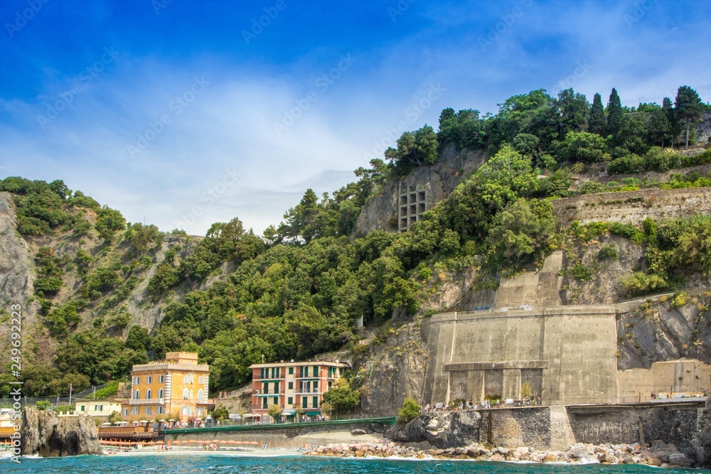 The town of Monterosso (Monterosso al Mare), one of the five small towns in the Cinque Terre national Park, Italy. Interesting depressions in the mountain. View from the excursion ship.