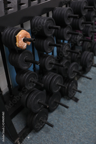 a donut is on a weight rack, a metaphor for a tough life choice