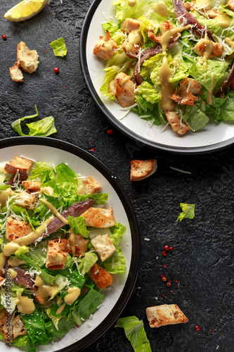 Caesar salad with chicken, anchous fish, croutons, parmesan cheese and greens. healthy food