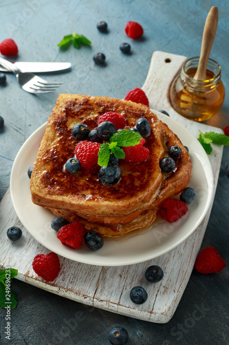 French cinnamon toast with blueberries, raspberries, maple syrup and coffee. morning breakfast