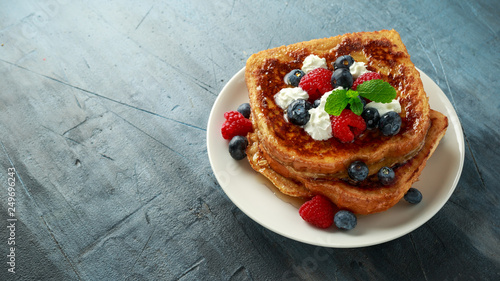 French cinnamon toast with blueberries, raspberries, maple syrup and coffee. morning breakfast