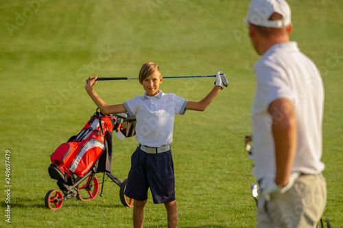 11 years old boy is happy to practice golf