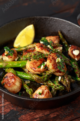 Scallops seared in garlic and parsley butter served in cast iron skillet