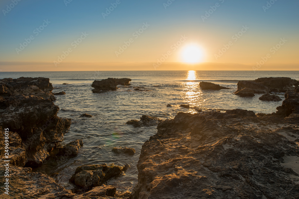 A sunrise between the rocks of Oropesa del Mar